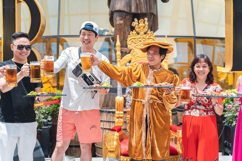 Visitors Gleefully Raise A Glass Of German Beer